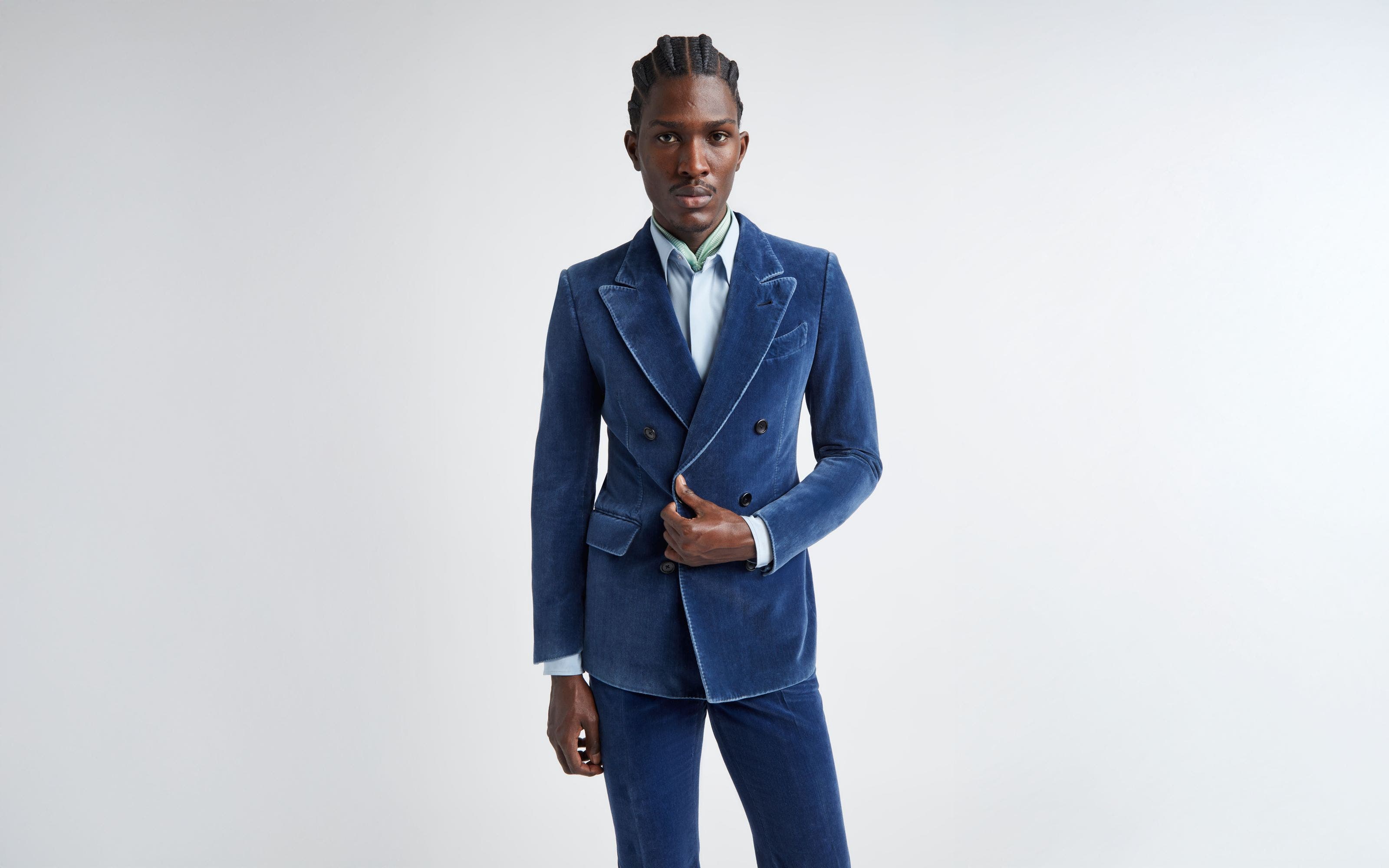 A man wearing a blue velvet double-breasted suit.