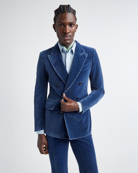 A man wearing a blue velvet double-breasted suit.