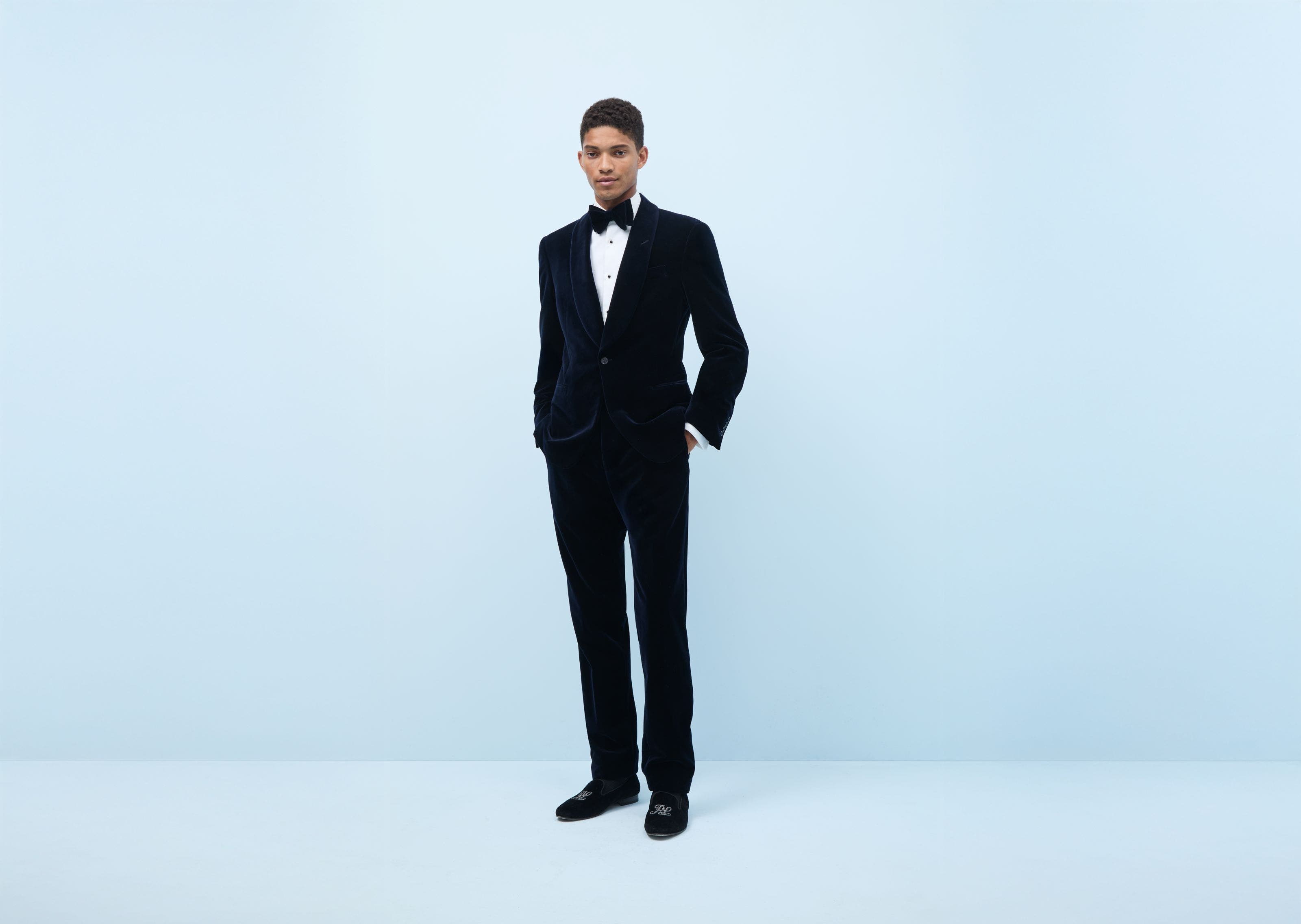 Man wearing a tuxedo and dress shoes.