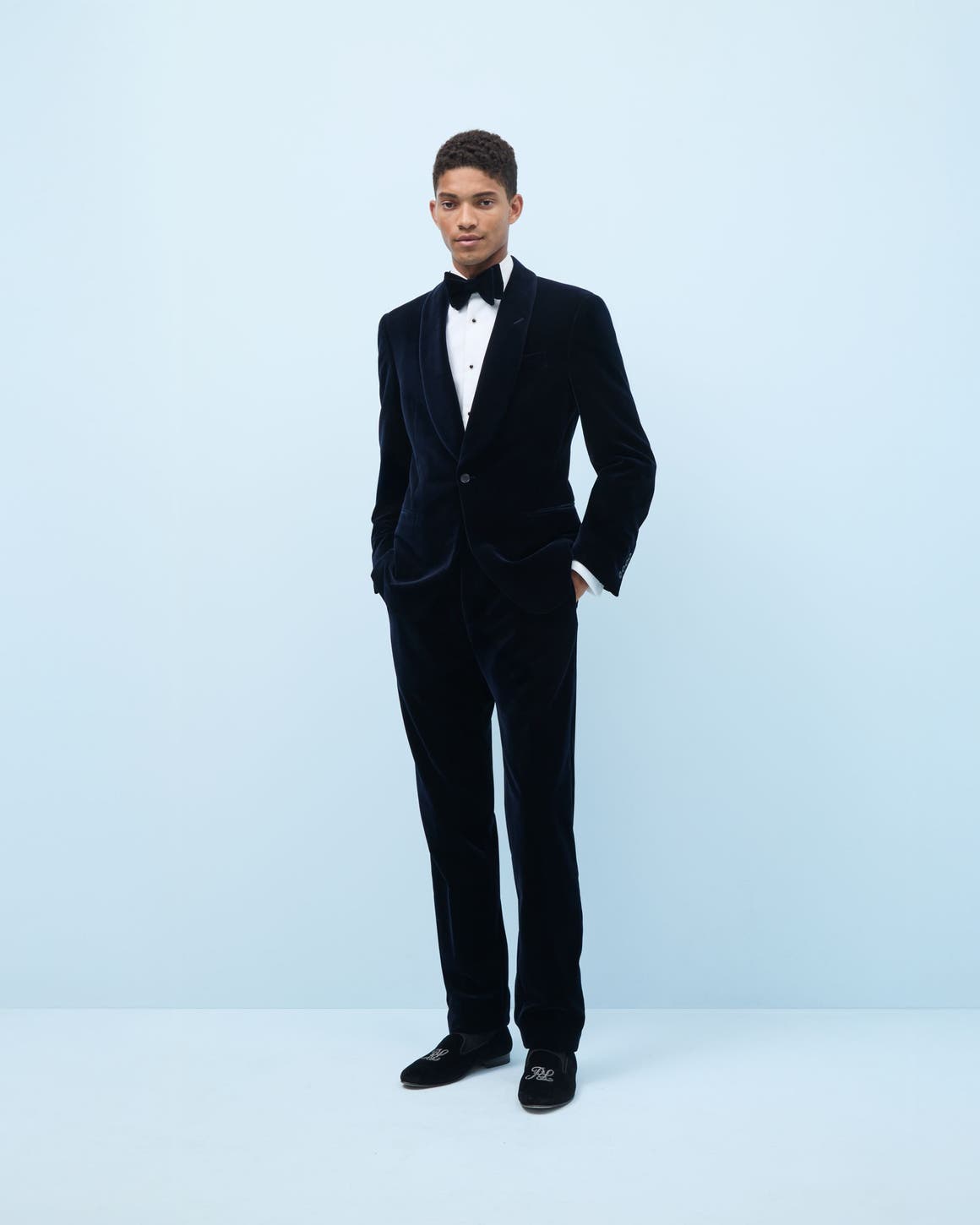 Man wearing a tuxedo and dress shoes.