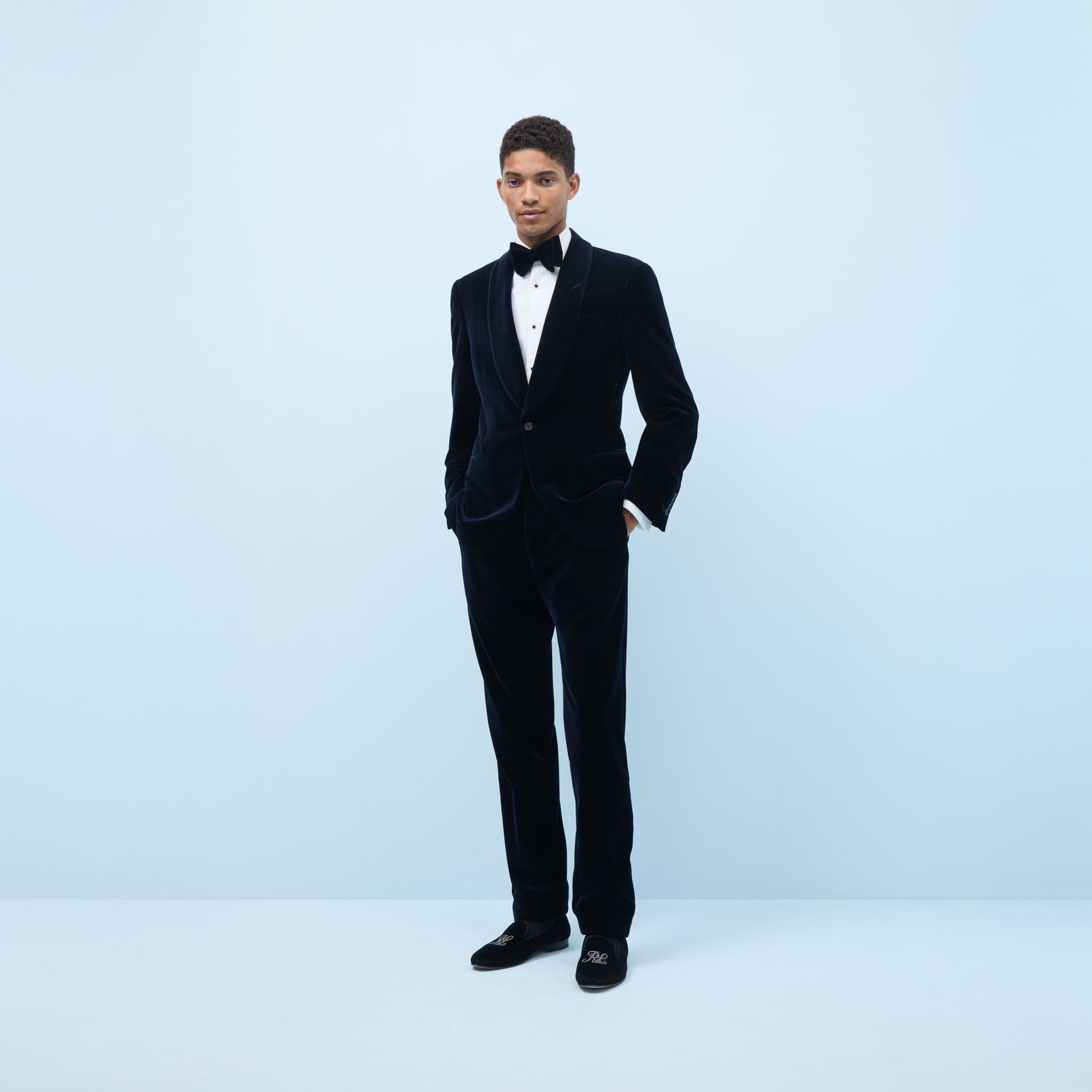 Man wearing a tuxedo and dress shoes.
