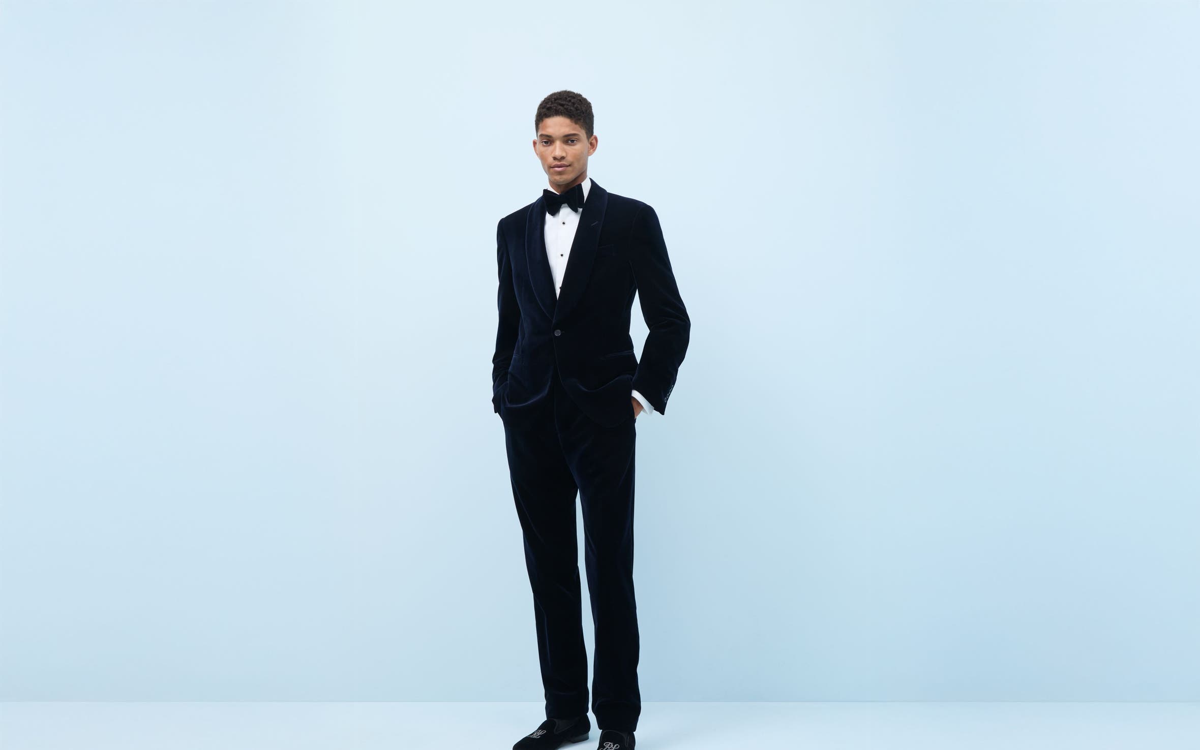 Man wearing a tuxedo and dress shoes.
