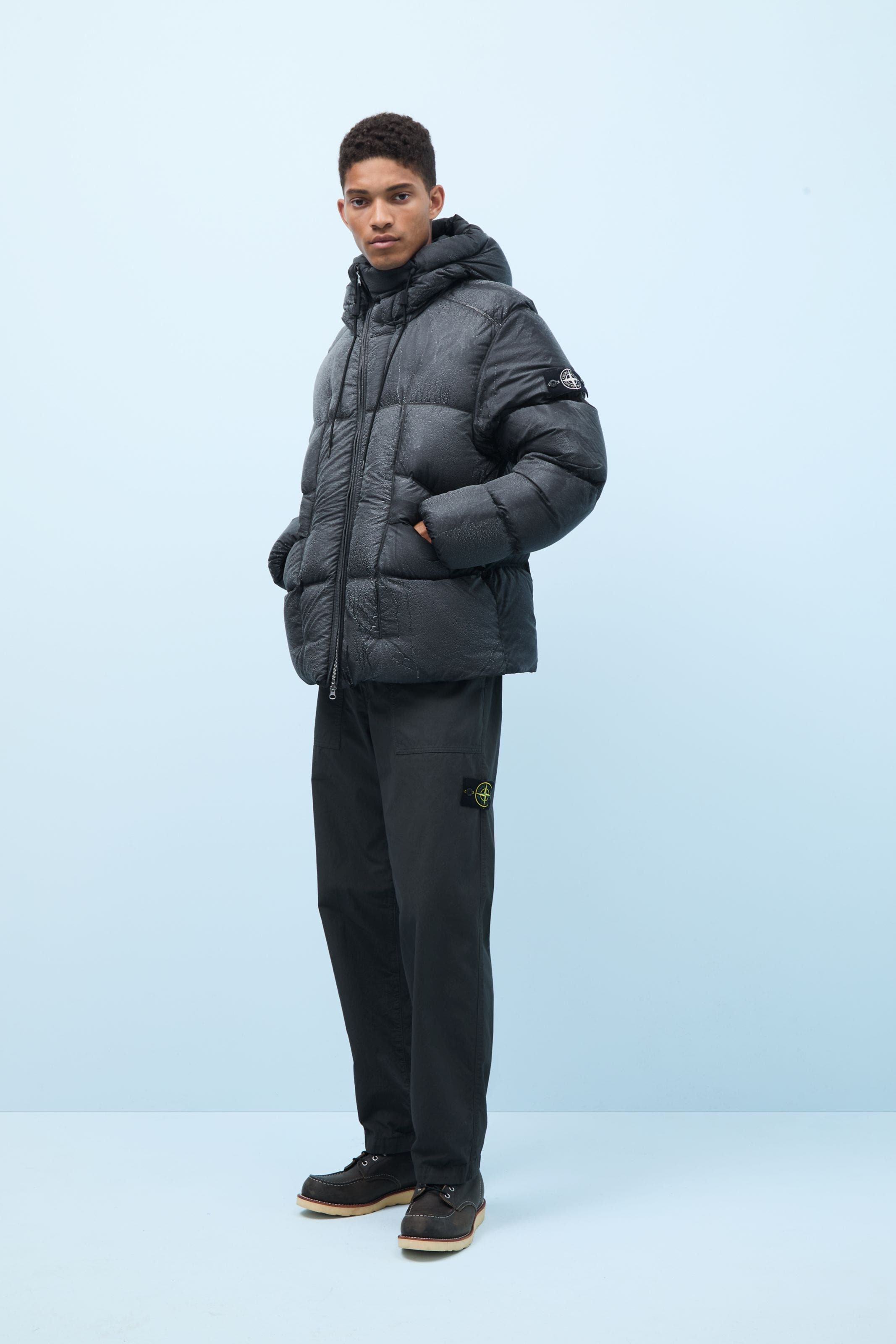 A man wearing a Stone Island down puffer coat.