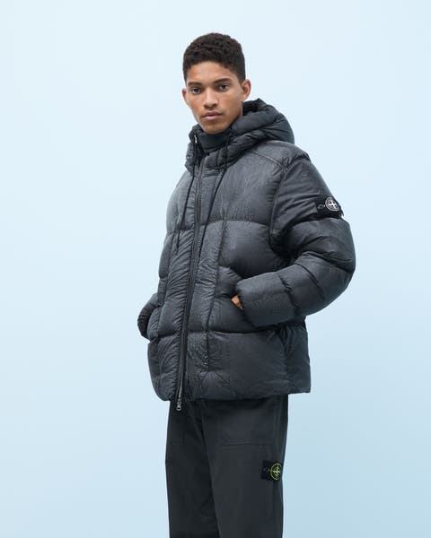 A man wearing a Stone Island down puffer coat.