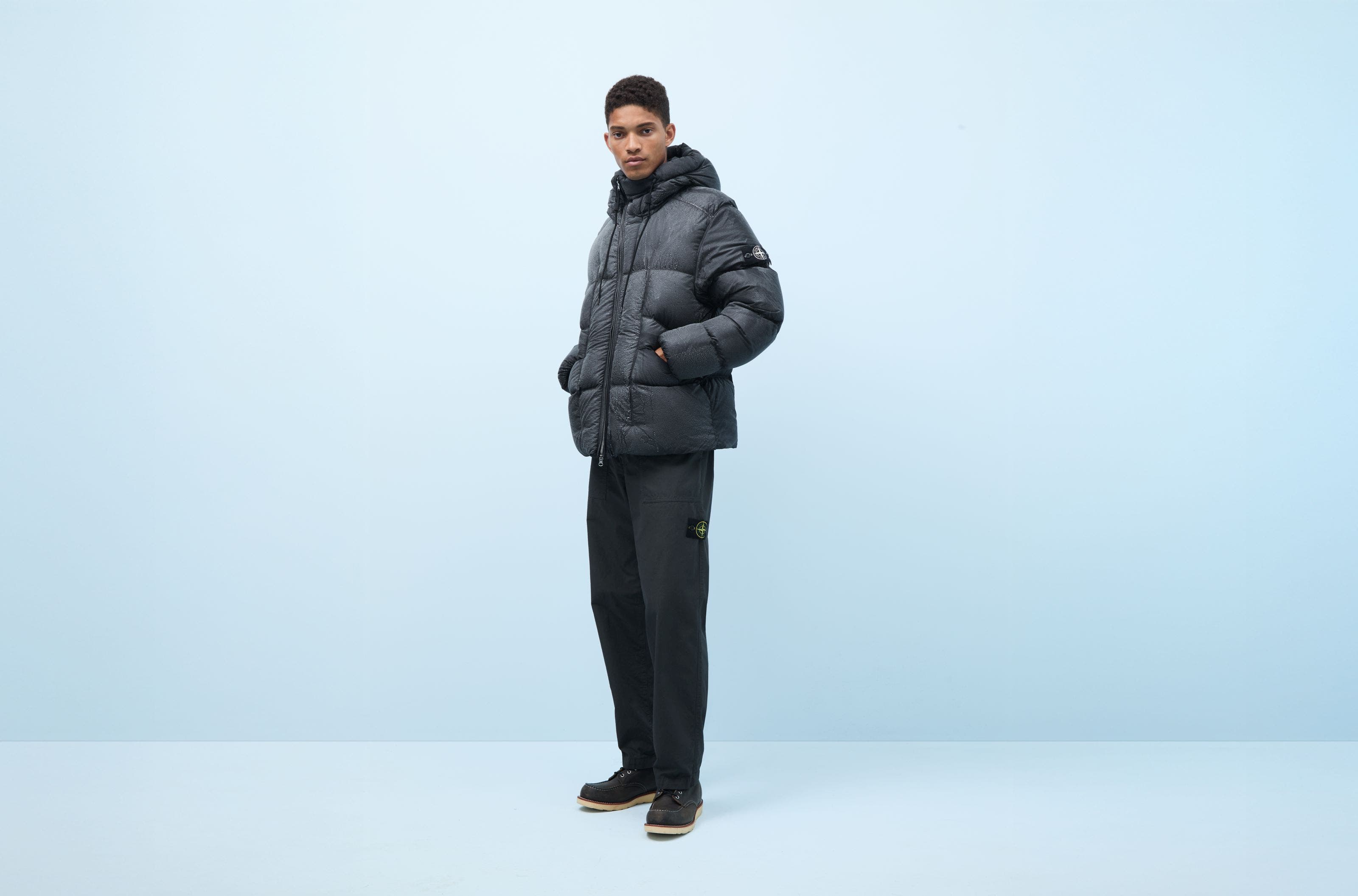 A man wearing a Stone Island down puffer coat.