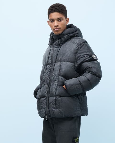 A man wearing a Stone Island down puffer coat.