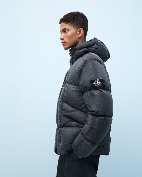 A man wearing a Stone Island down puffer coat.