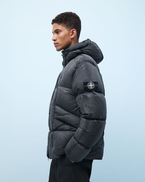 A man wearing a Stone Island down puffer coat.