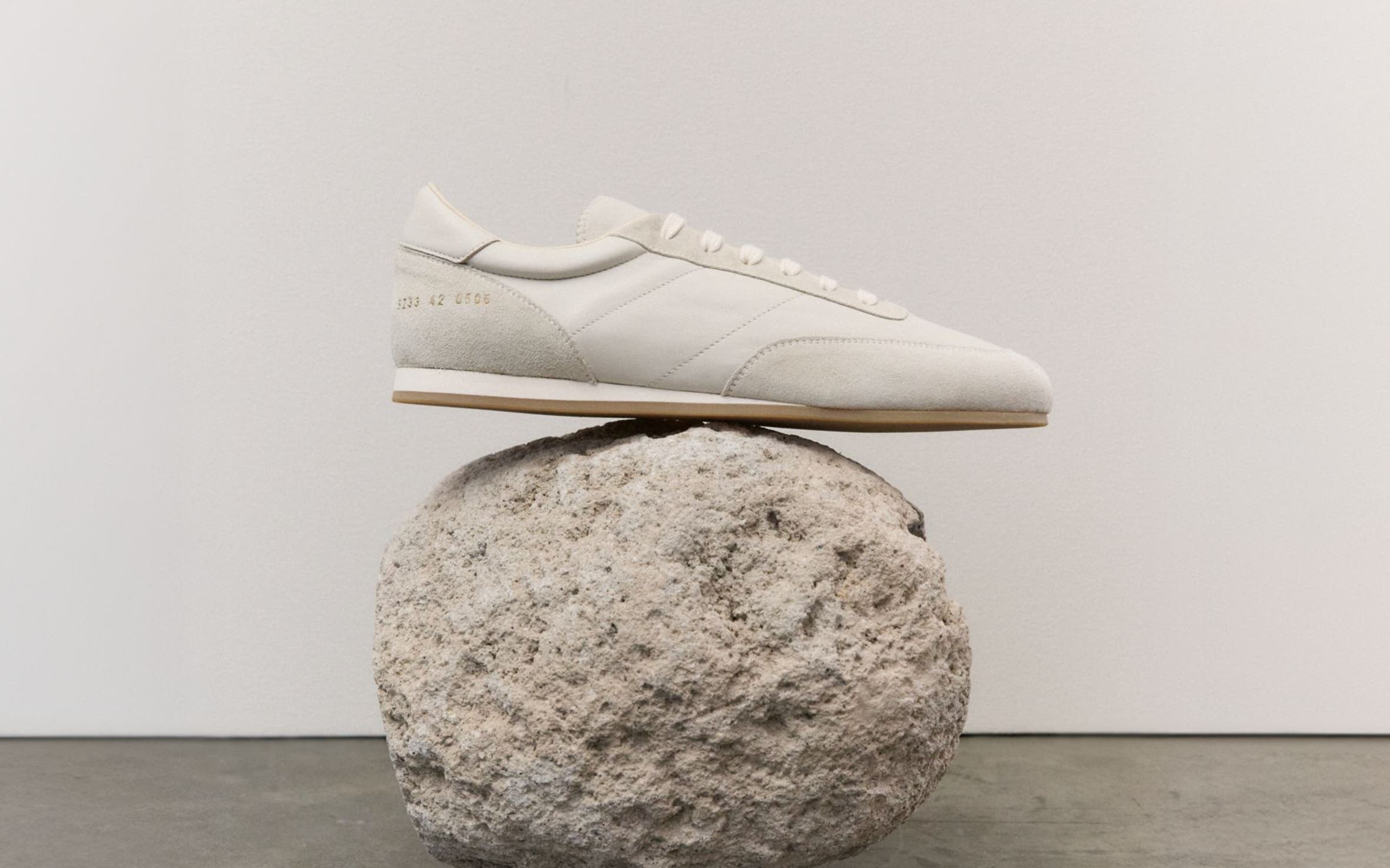 A sneaker balanced on a rock.
