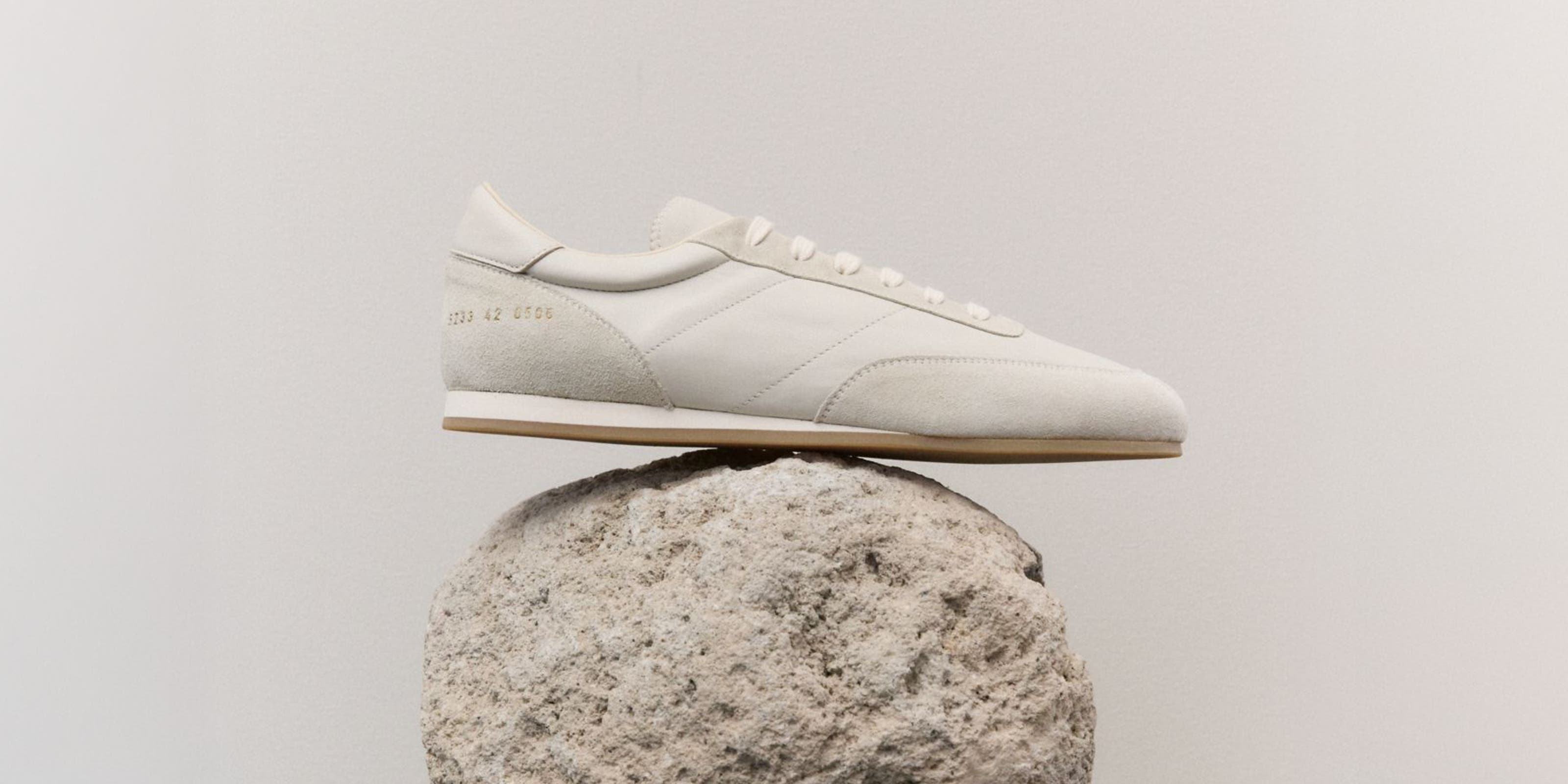 A sneaker balanced on a rock.