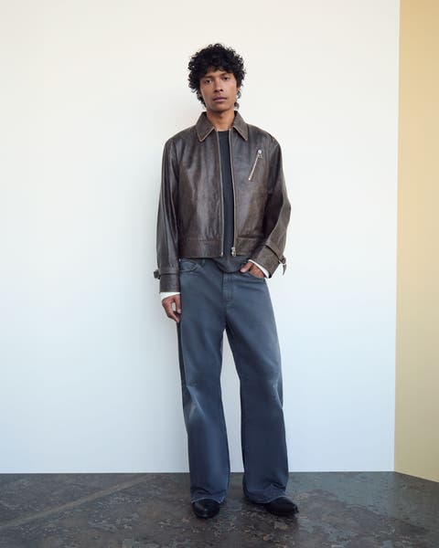 A man wearing a designer jacket and pants.