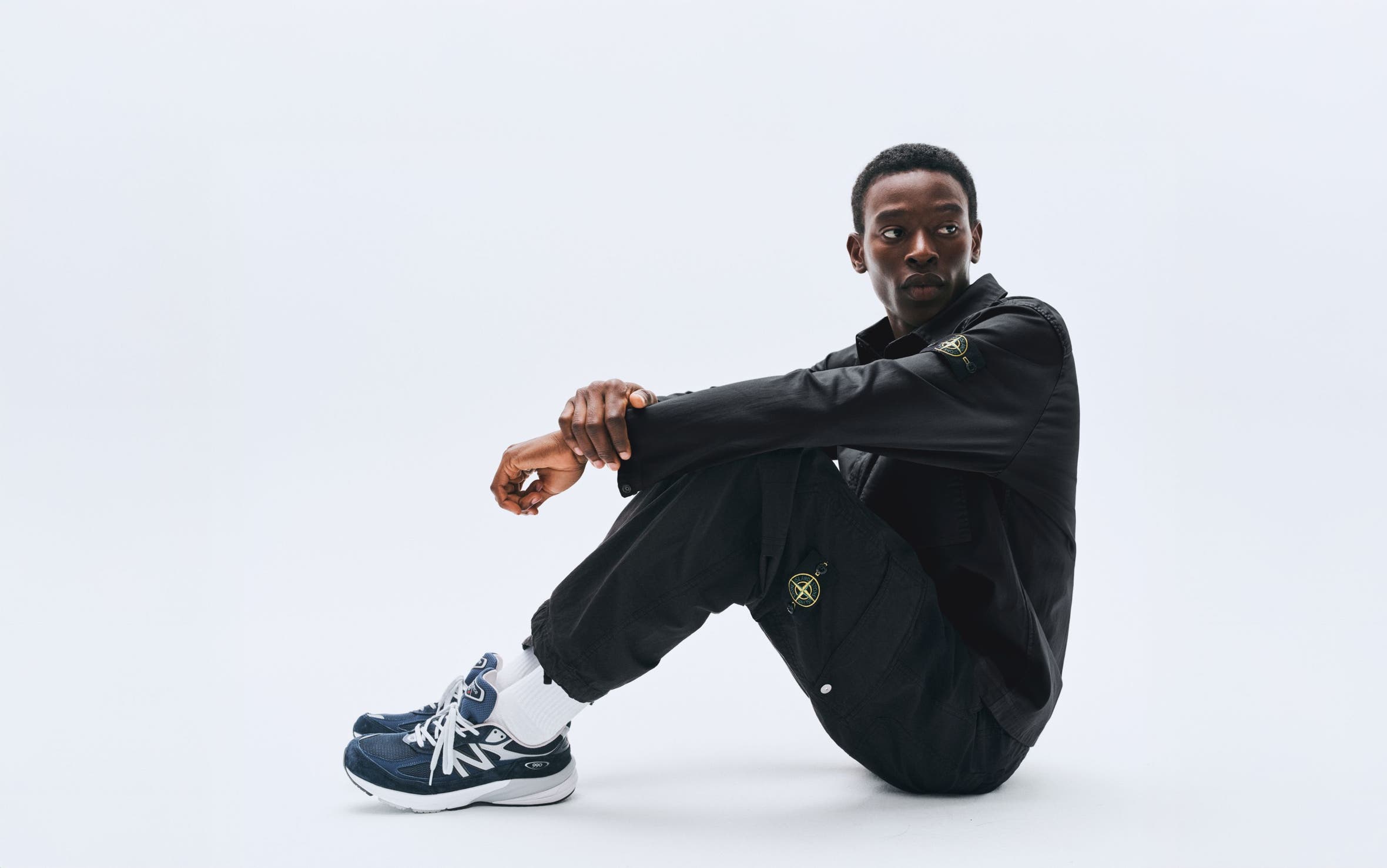 A model wearing a black jacket and pants.