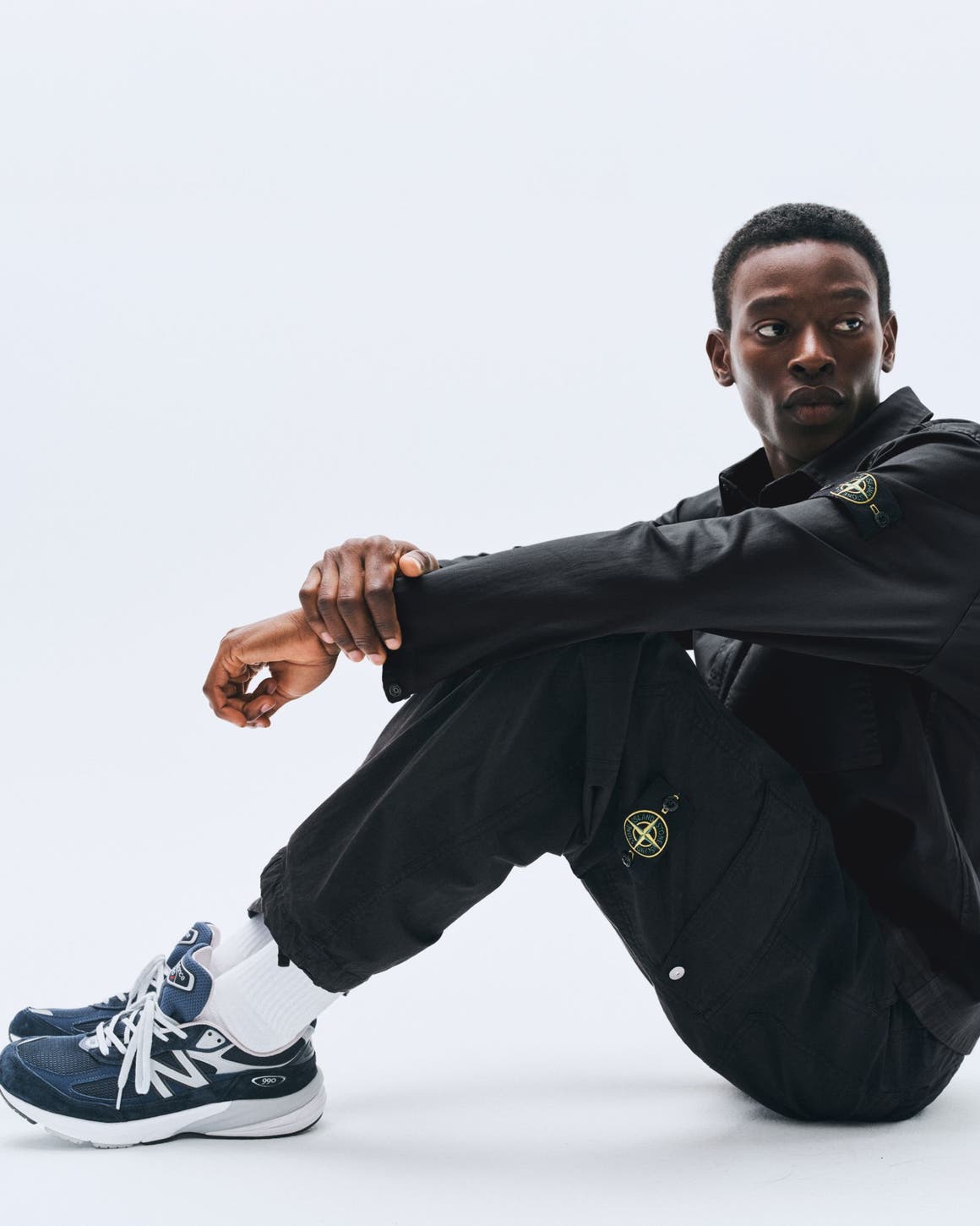 A model wearing a black jacket and pants.