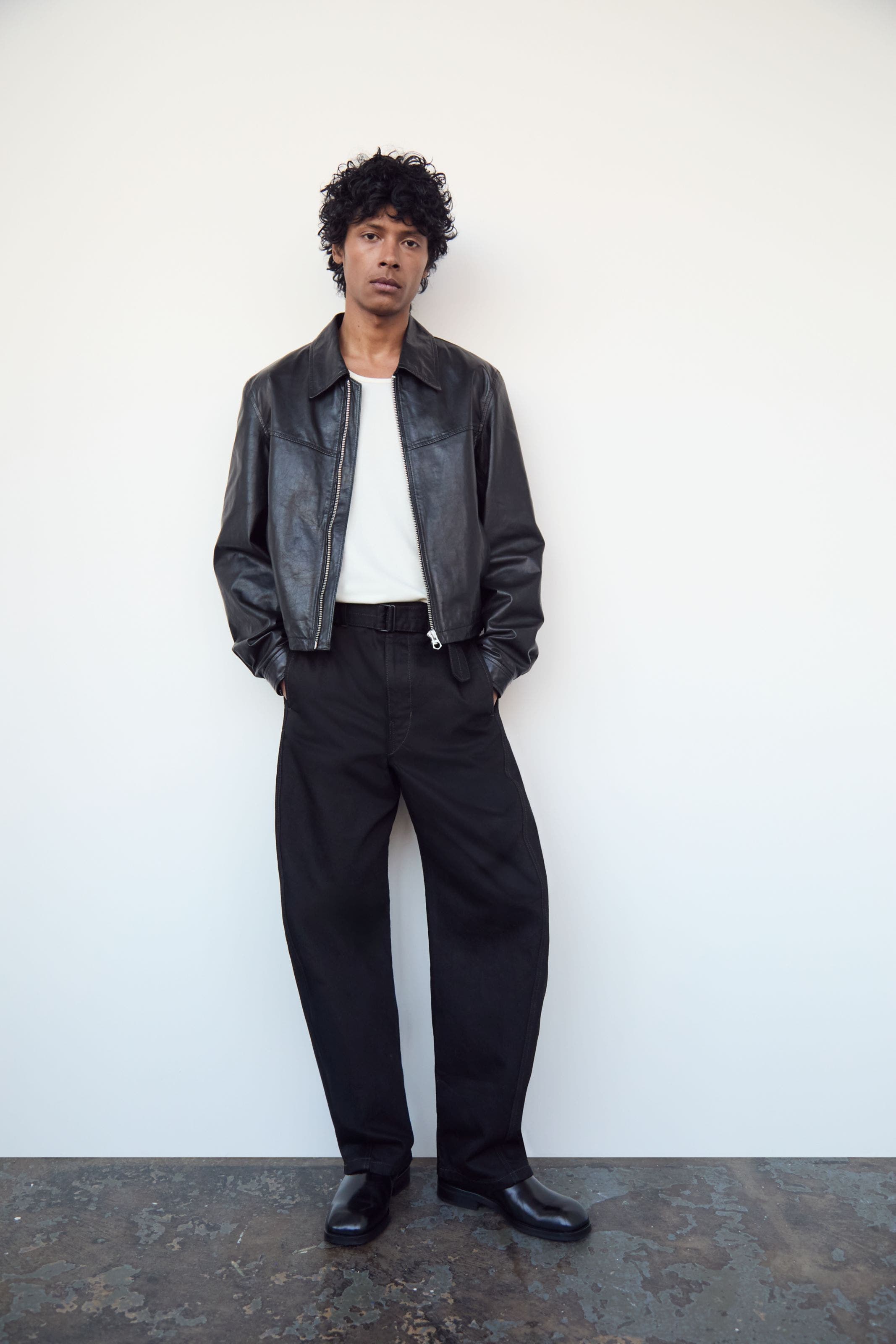 Man wearing Lemaire jacket, T-shirt, pants and shoes.