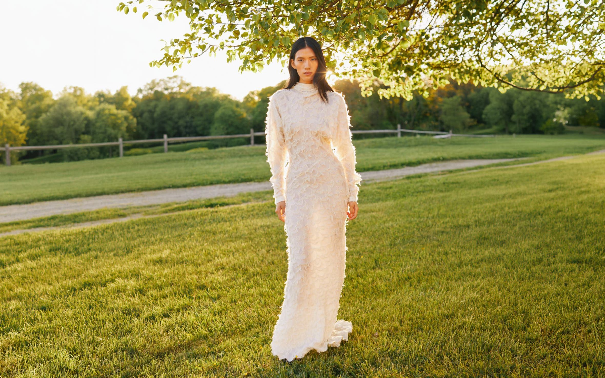 Woman wearing long white lace gown.
