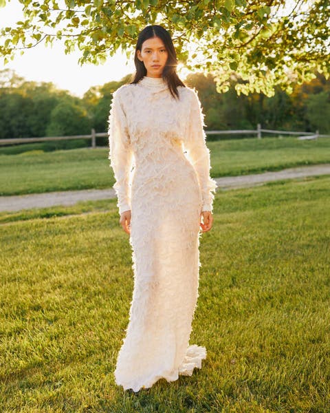 Woman in full length lace gown.
