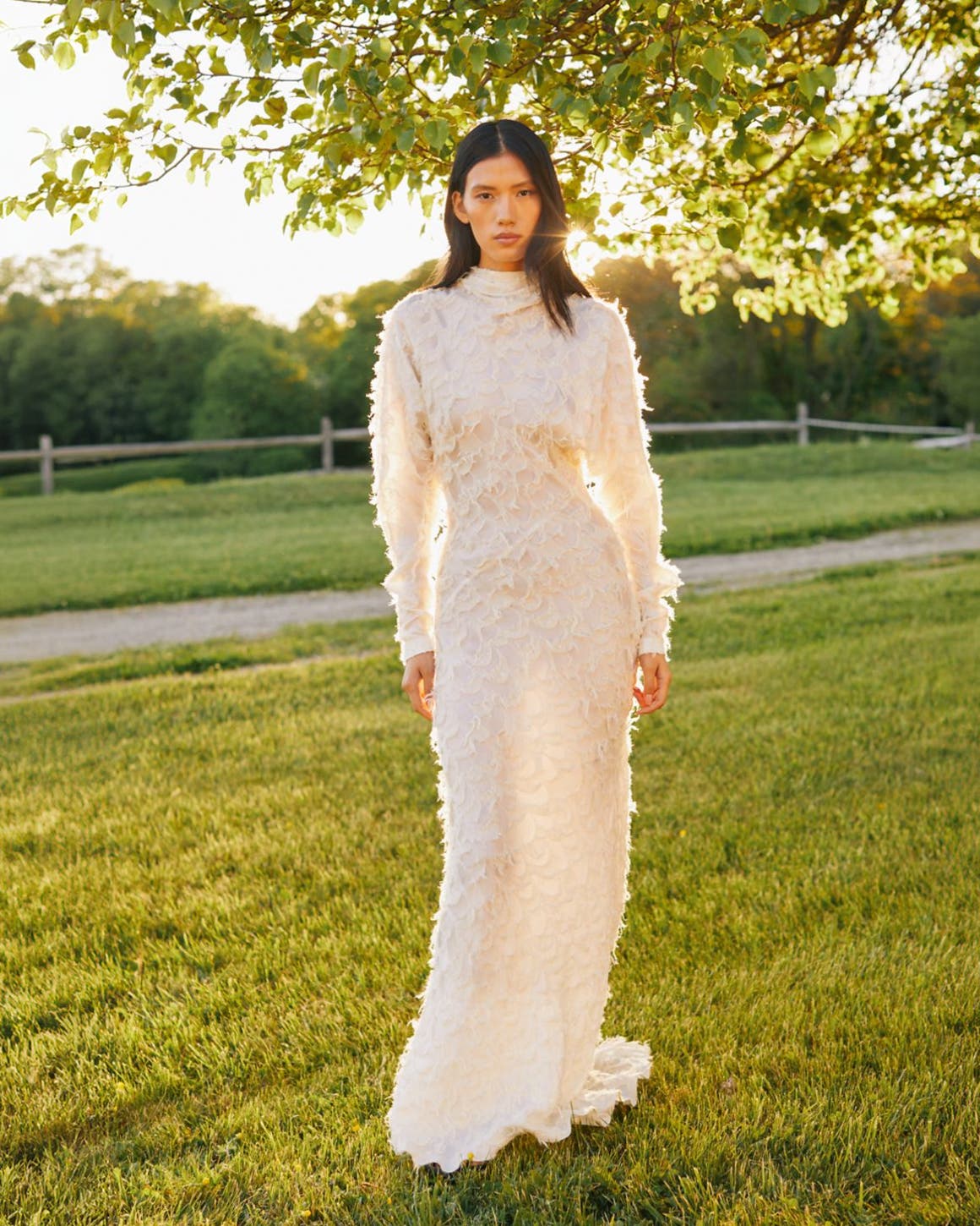 Woman wearing long white lace gown.