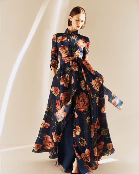 Woman wearing a floral evening gown.