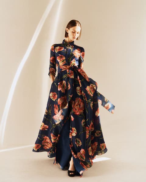 Woman wearing a floral evening gown.