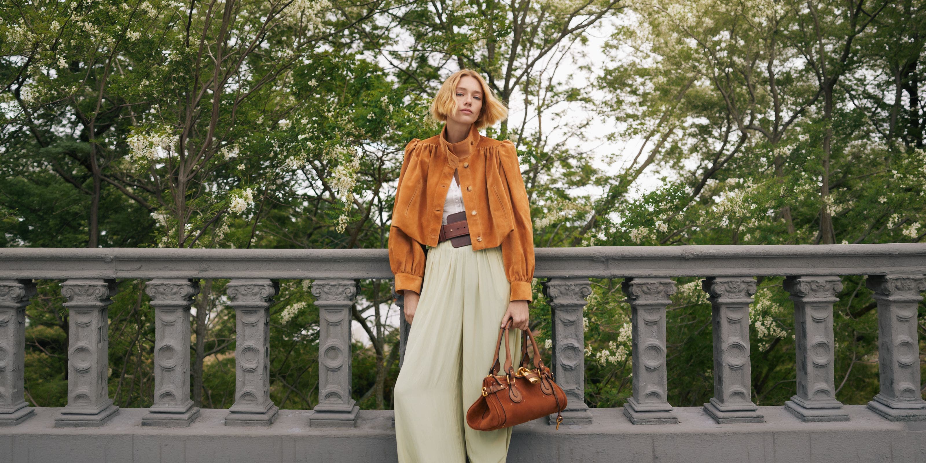 A woman in Chloe suede jacket and trousers