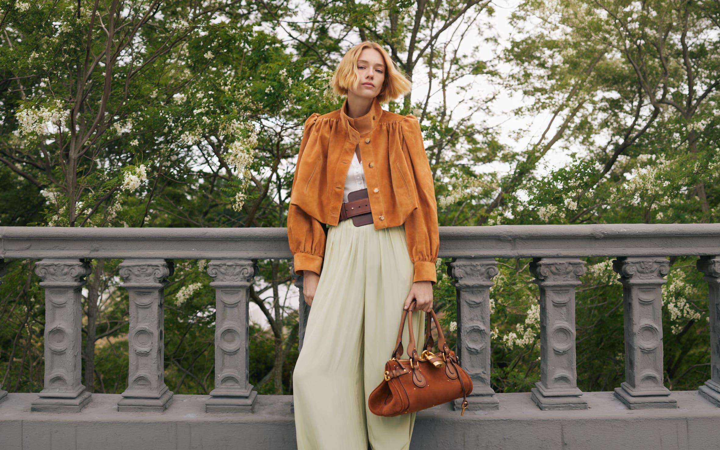 A woman in Chloe suede jacket and trousers