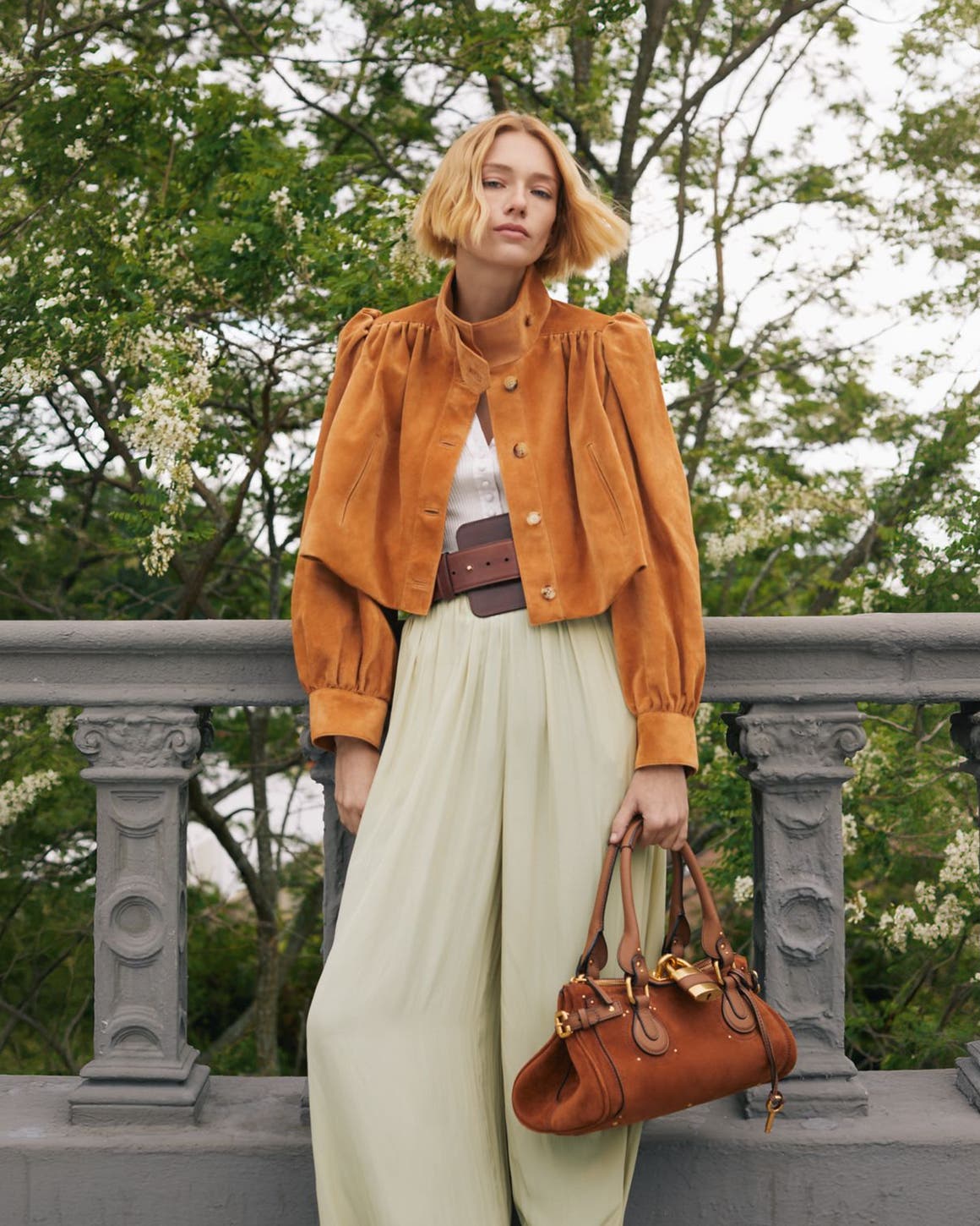 A woman in Chloe suede jacket and trousers