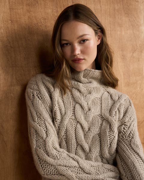 women is a chunky cable knit sweater