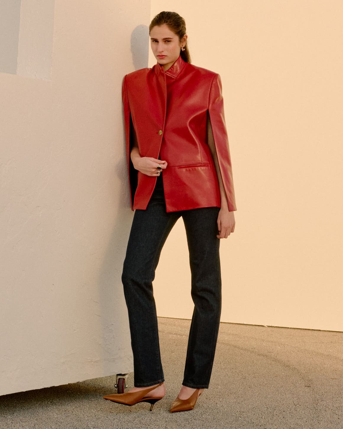 Woman wearing Khaite jacket, jeans and slingback pumps.