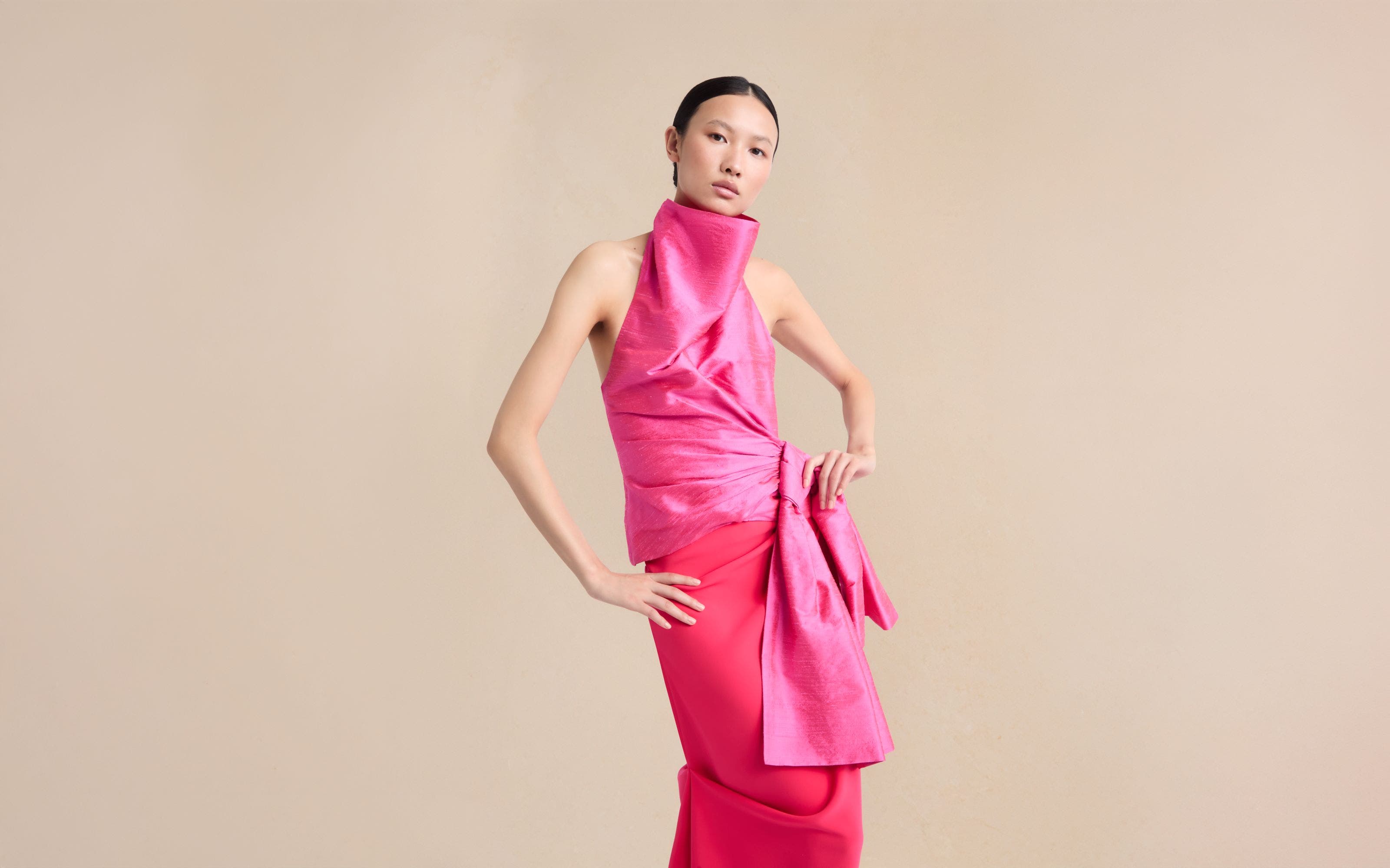 Woman wearing Christopher John Rogers top and skirt.
