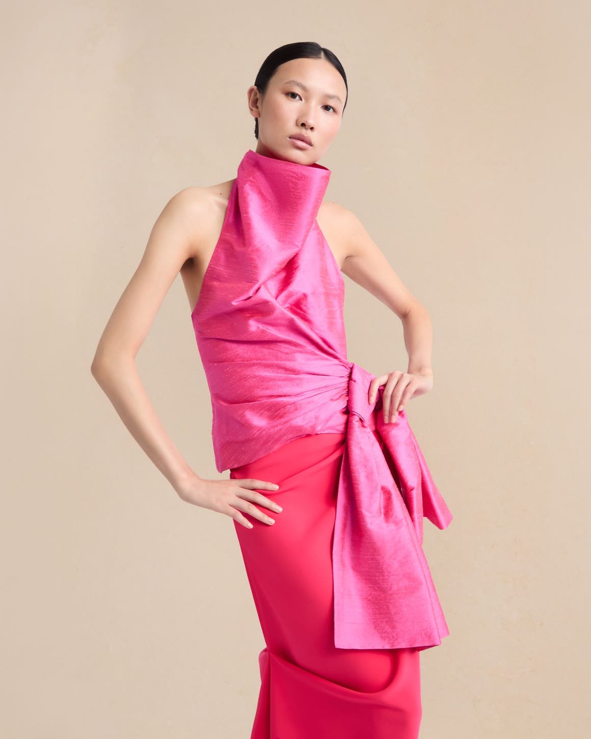 Woman wearing Christopher John Rogers top and skirt.