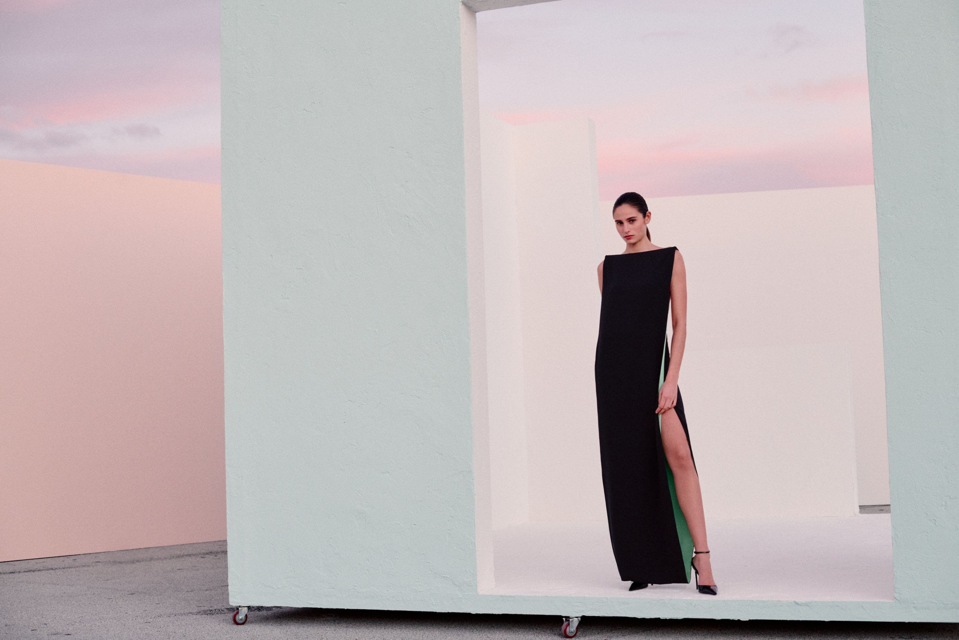 Woman wearing a black evening gown and heels.
