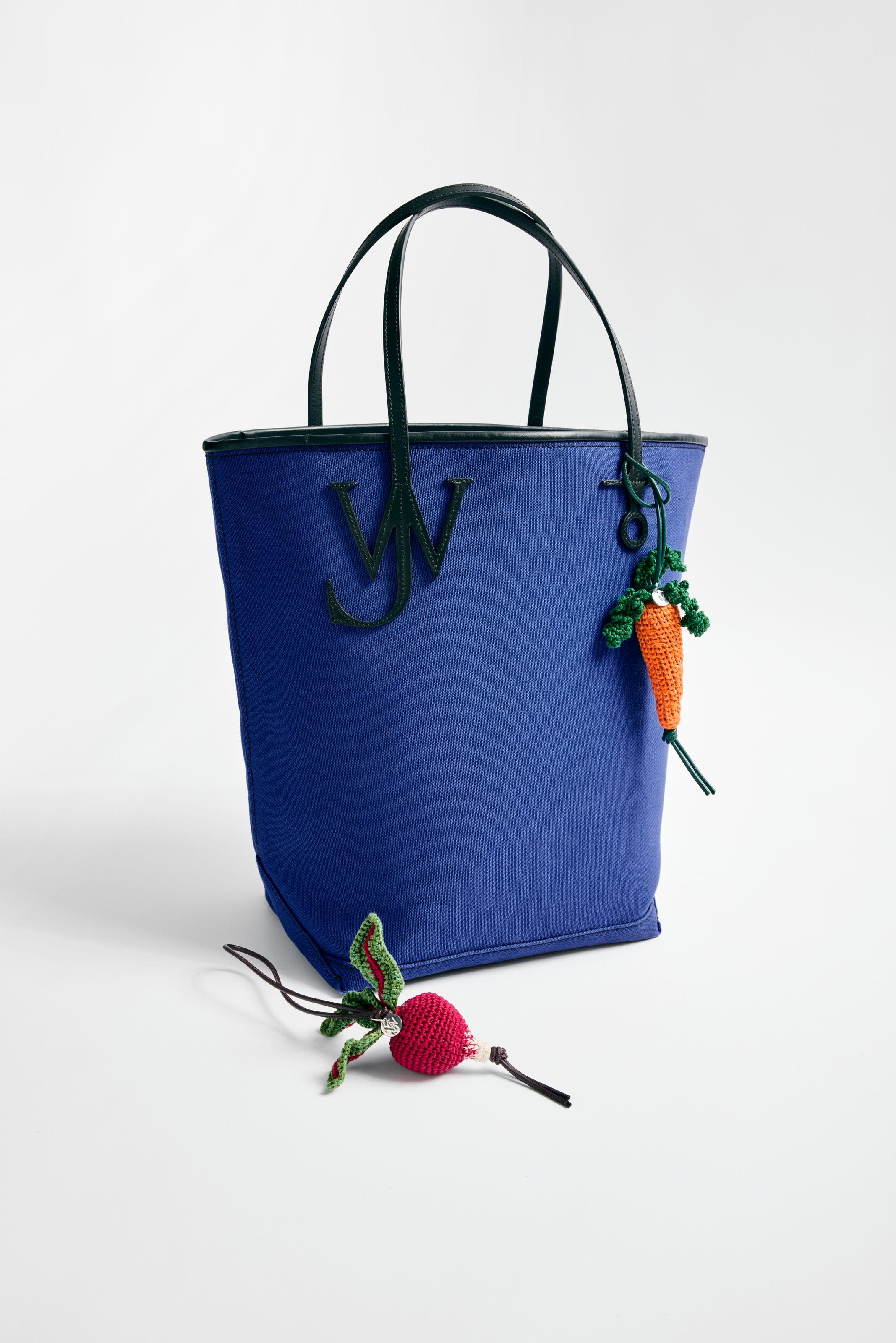 JW Anderson handbag in blue with bag charms.