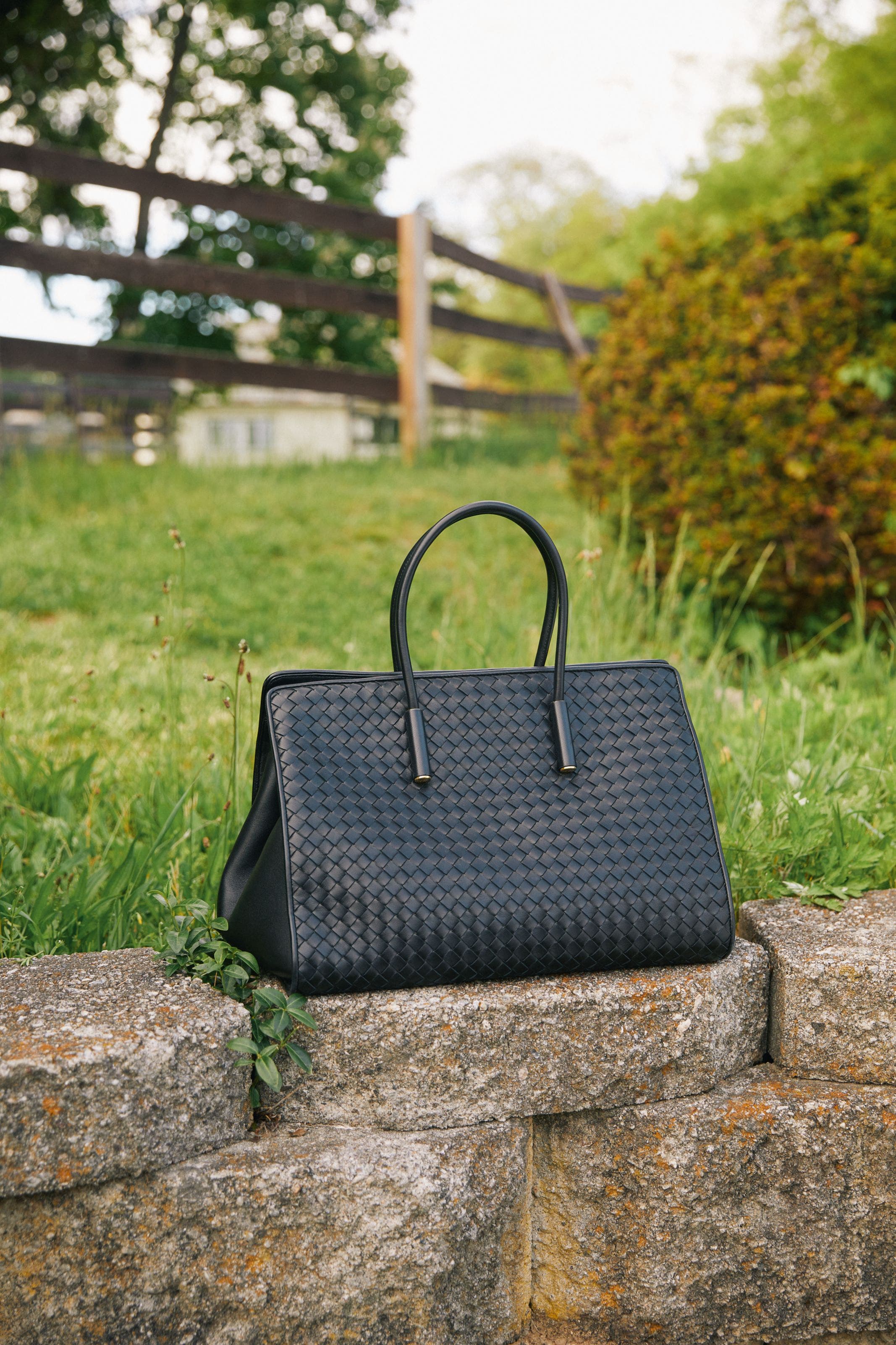Women's black textured handbag.