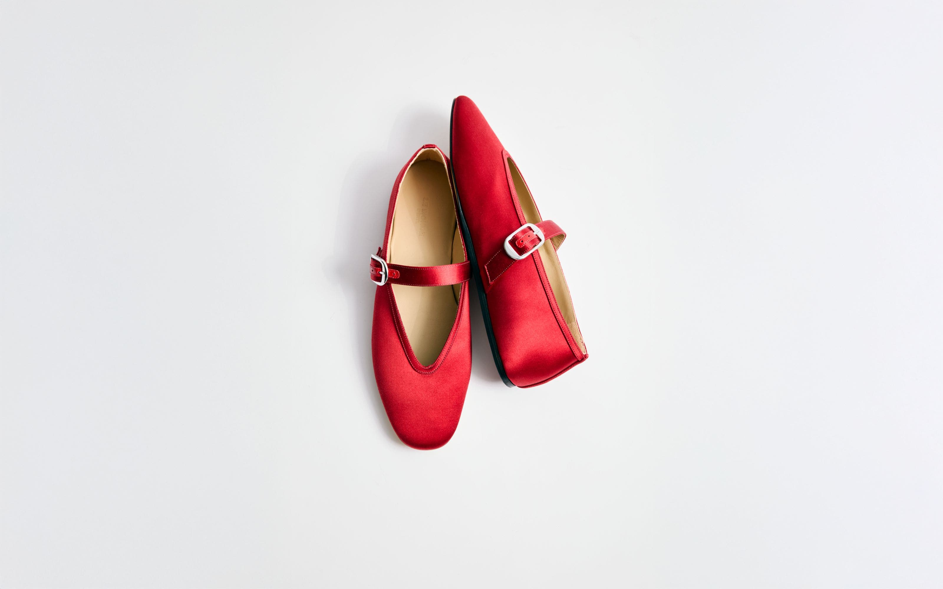 Red satin Mary Jane flats.