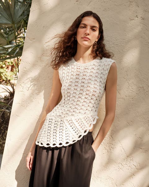 Woman wearing a crocheted LOULOU DE SAISON top.