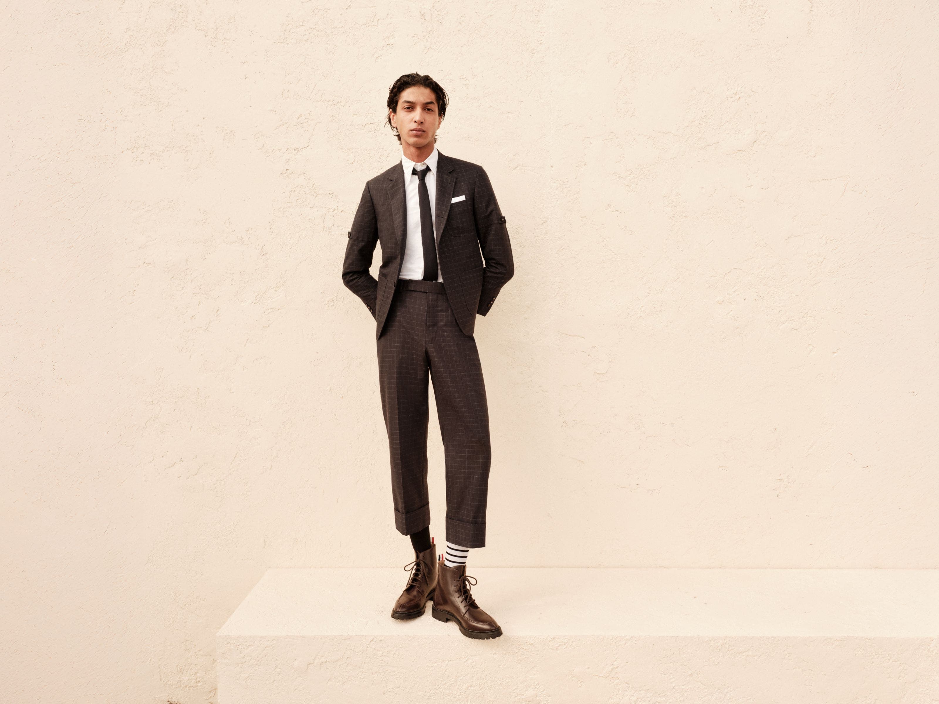 Man wearing a Thom Browne jacket and pants.