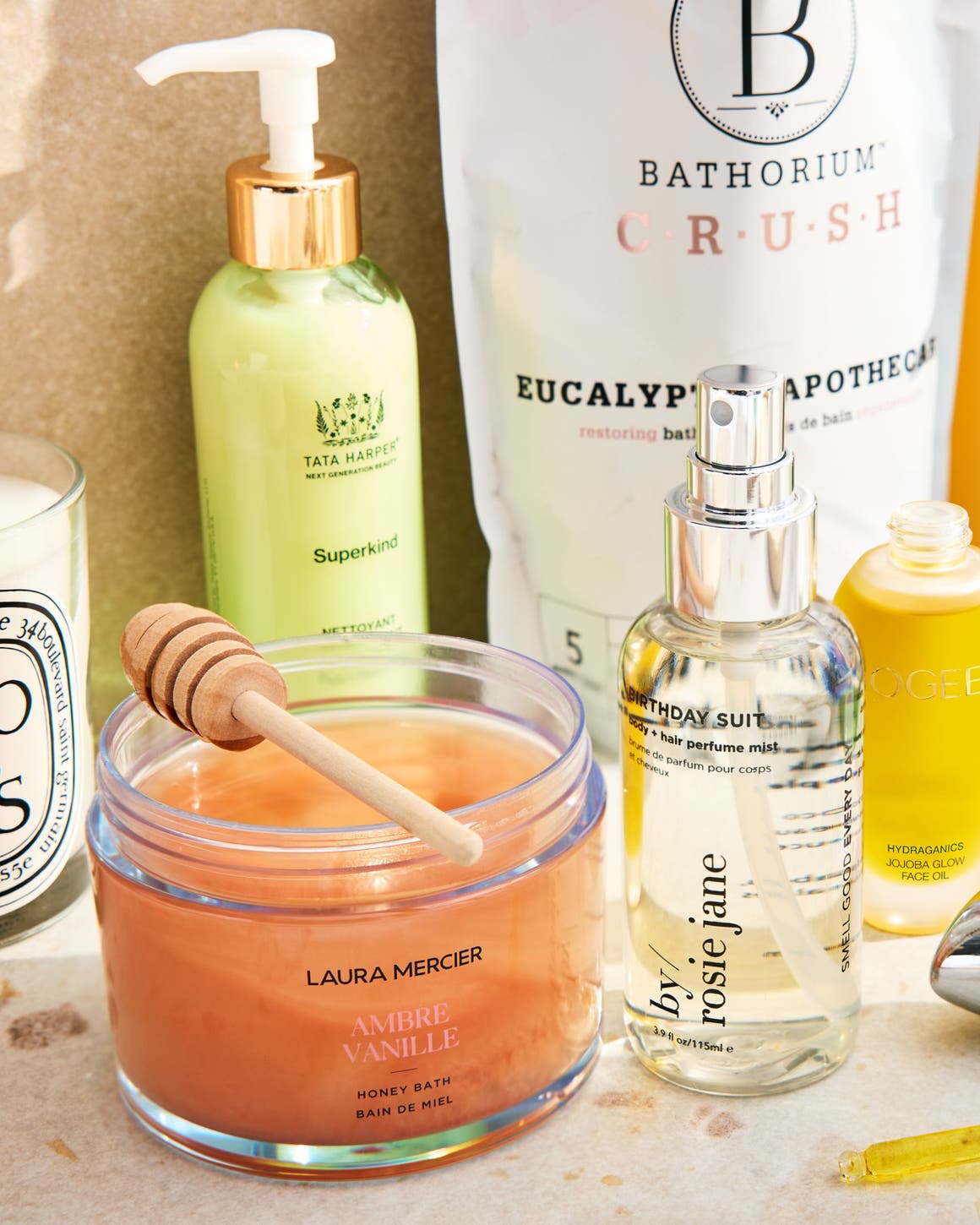 An assortment of skin care, bath and fragrance products on a countertop.