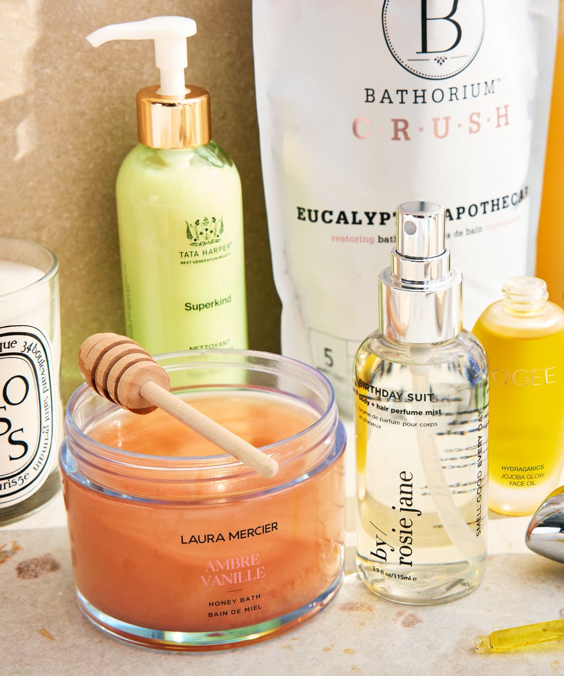 An assortment of skin care, bath and fragrance products on a countertop.
