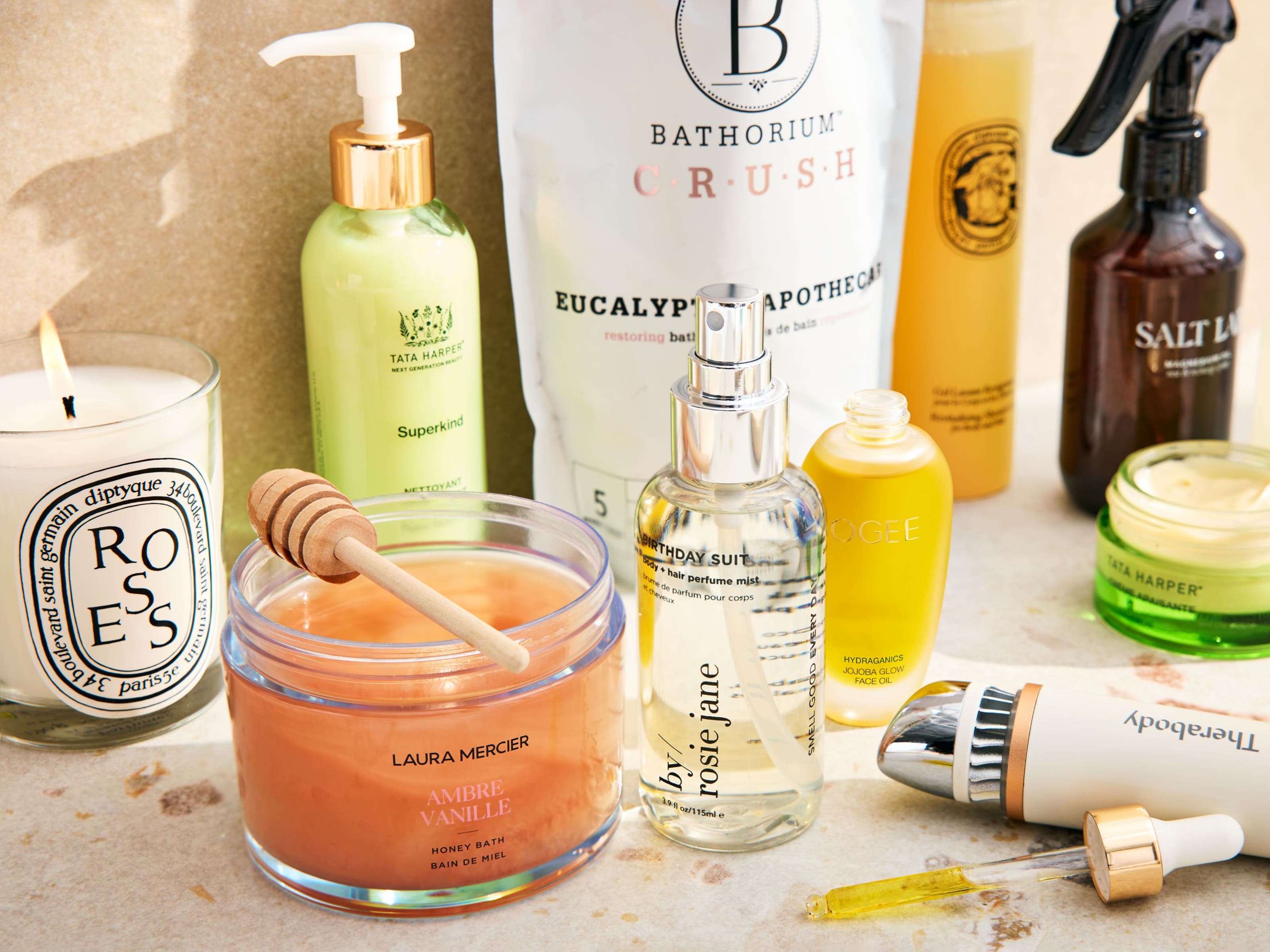 An assortment of skin care, bath and fragrance products on a countertop.
