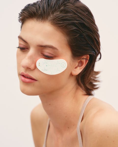 A woman with wearing an OMNILUX eye device. 