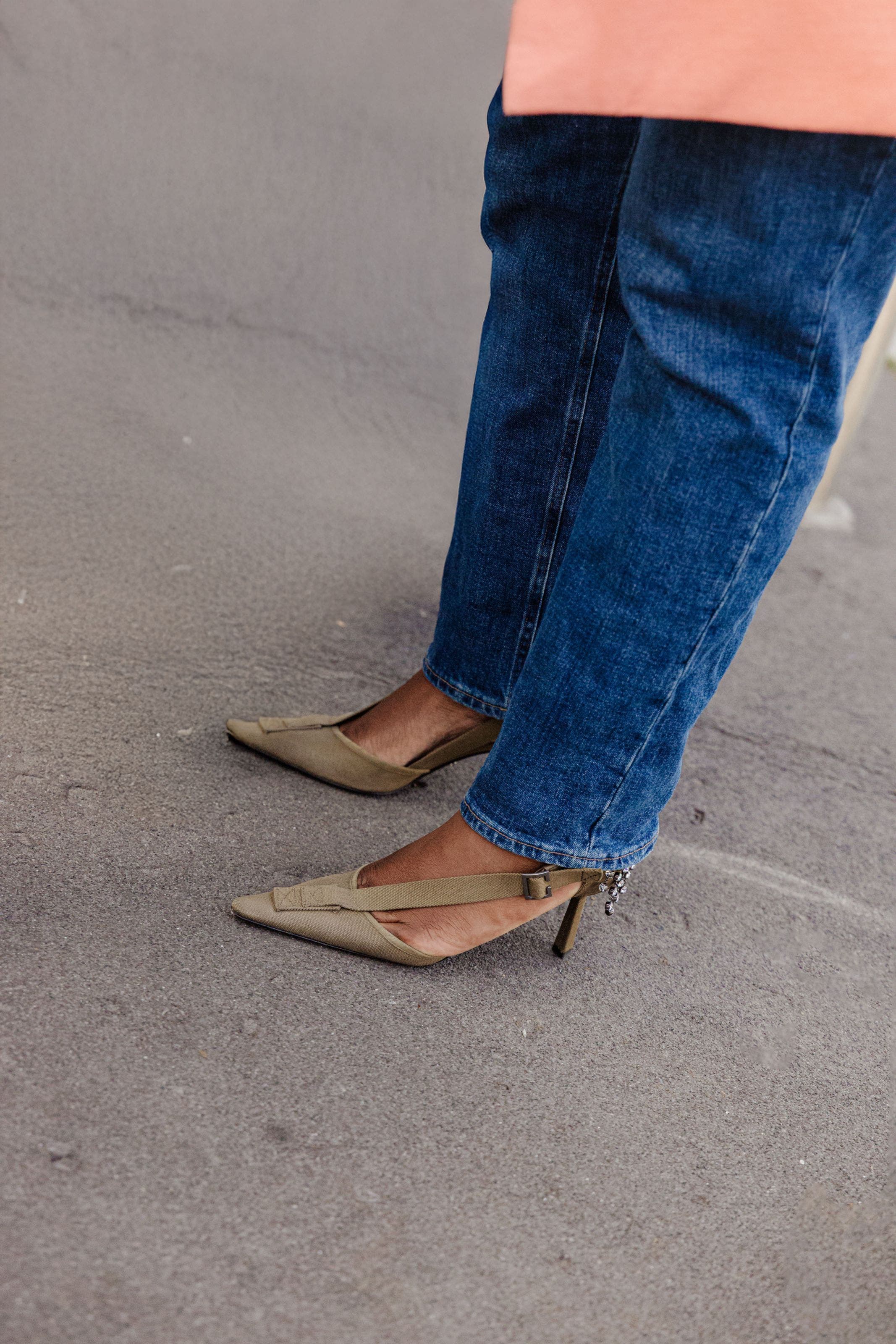 Woman wearing jeans and Prada heels at Milan Fashion Week.