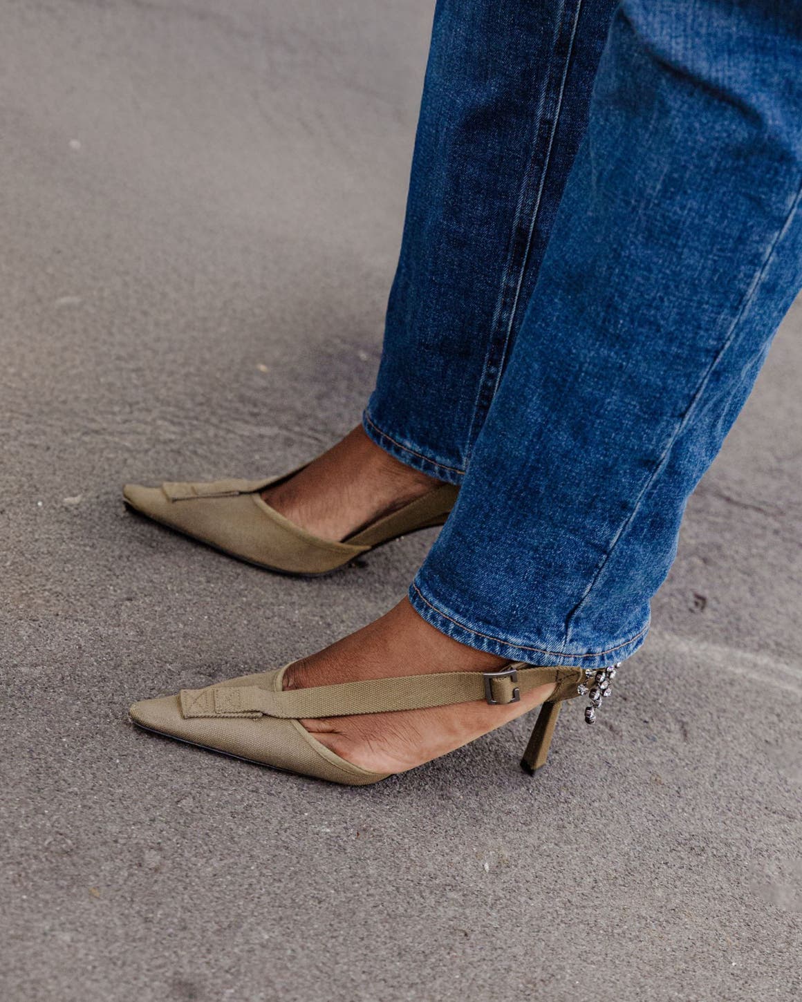 Woman wearing jeans and Prada heels at Milan Fashion Week.
