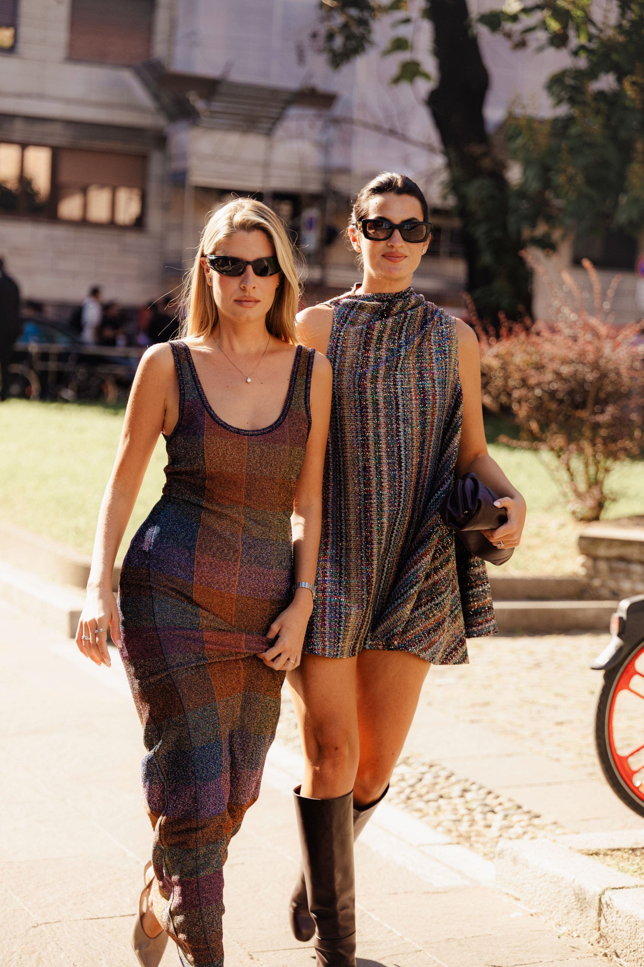 Two women wearing knit dresses.