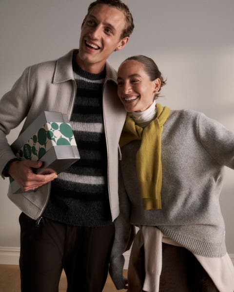 A woman and man holding a Nordstrom gift box.