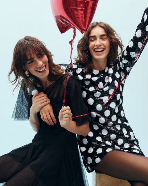 Two women wearing party dresses.