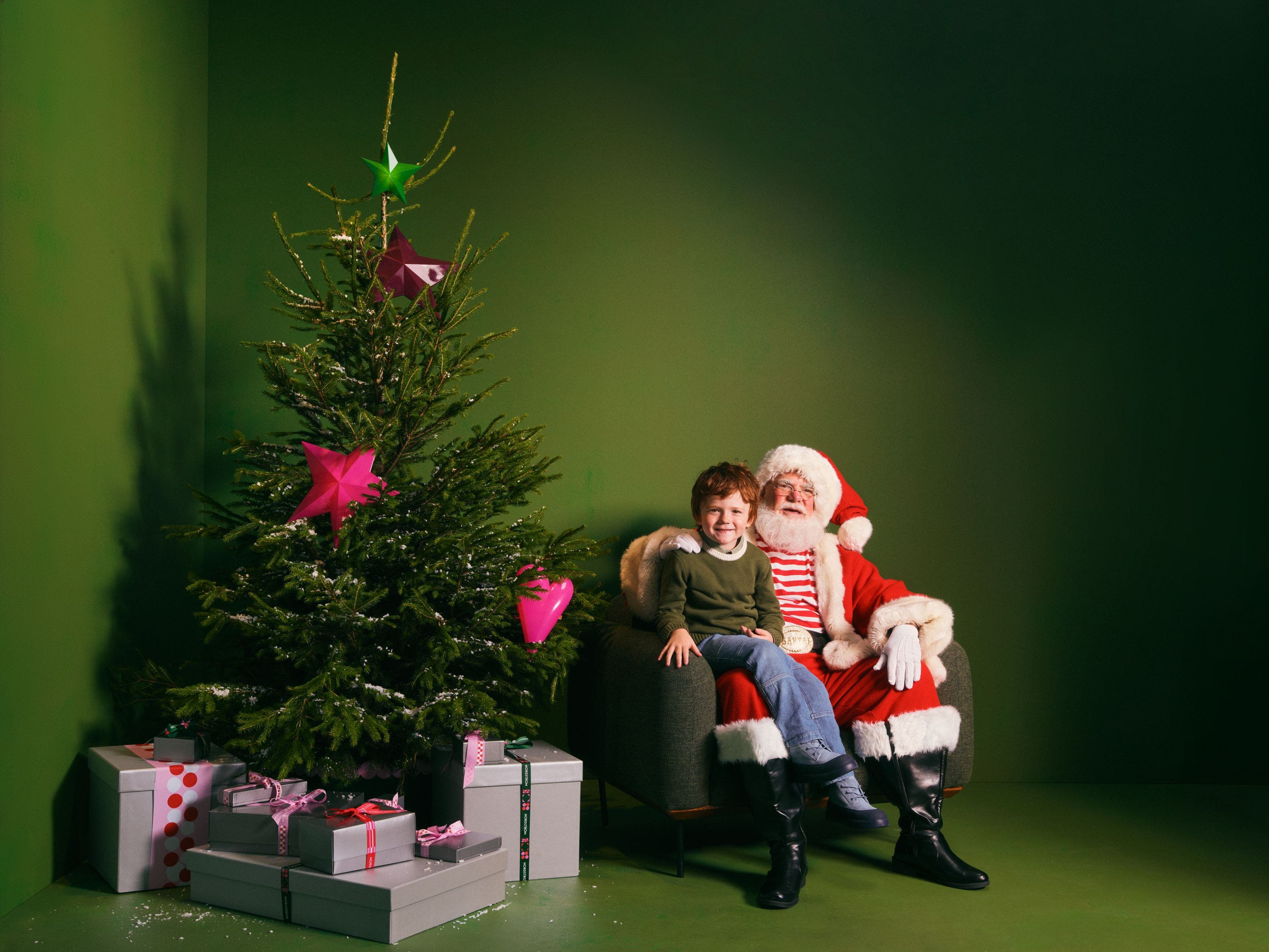 A boy sitting on Santa
s lap.