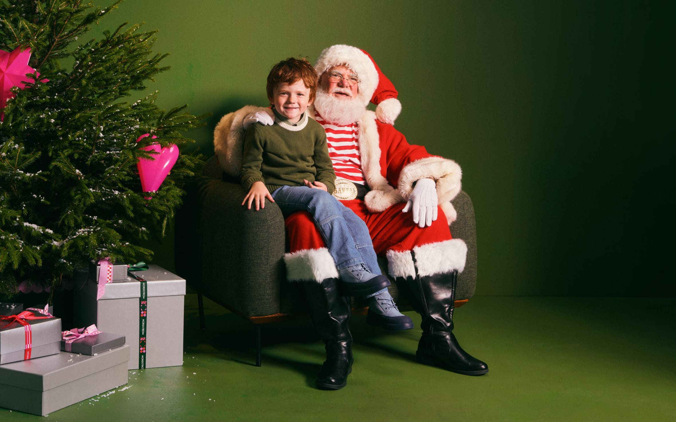 A boy sitting on Santa's lap.