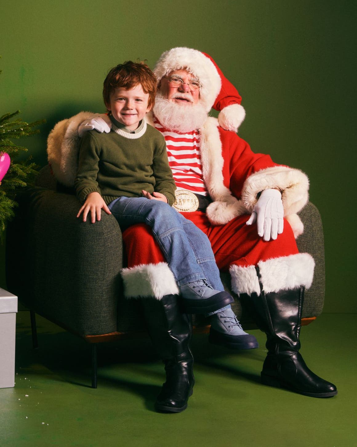 A boy sitting on Santa's lap.