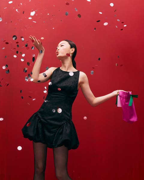 A woman wearing a black bubble-hem party dress.