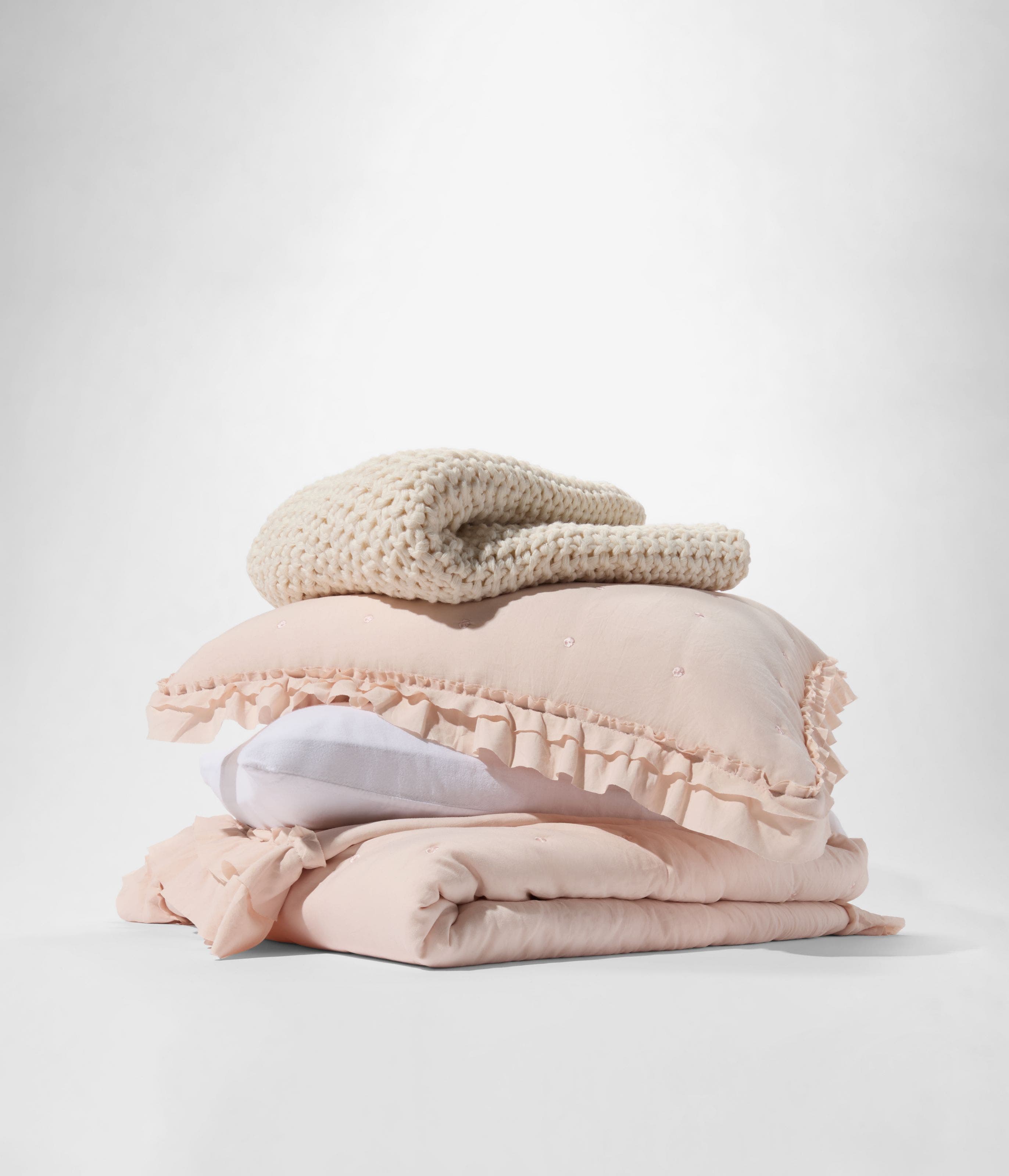 A stack of blankets and pillows.